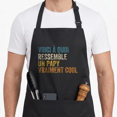 Tablier de cuisine noir avec inscription colorée Voici à quoi ressemble un papy vraiment cool en typographie vintage.