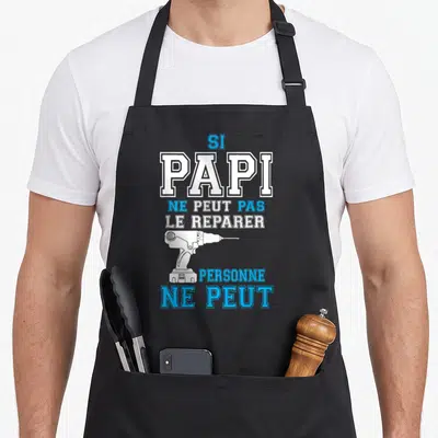 Tablier de cuisine noir avec inscription blanche et bleue Si Papi ne peut pas le reparer personne ne peut et une perceuse électrique.