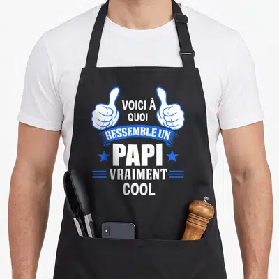 Tablier de cuisine noir avec deux mains blanches faisant des pouces levés et le texte voici à quoi ressemble un papi vraiment cool en blanc et bleu.