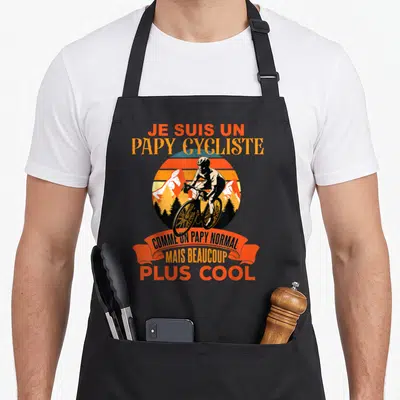 Tablier de cuisine noir avec illustration vintage d'un cycliste et texte orange Je suis un papy cycliste comme un papy normal mais beaucoup plus cool.