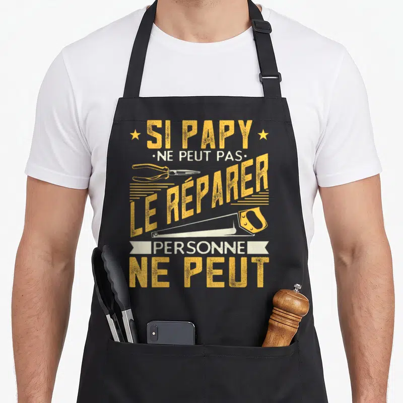 Tablier de cuisine noir avec inscription jaune et blanche sur le thème du bricolage de grand-père