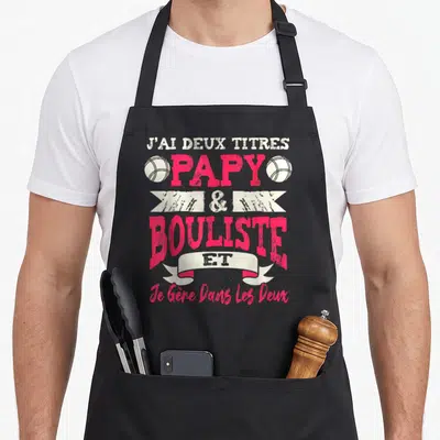 Tablier de cuisine noir avec inscription papy et bouliste en rose et balle de pétanque stylisée