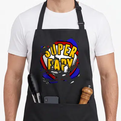 Tablier de cuisine noir avec motifSuper Papystyle comics jaunerougeet bleu