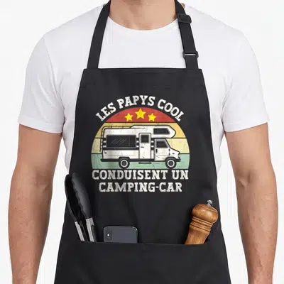 Tablier de cuisine noir avec illustration vintage d'un camping-car blanc sur fond arc-en-ciel et texte Les Papys Cool.