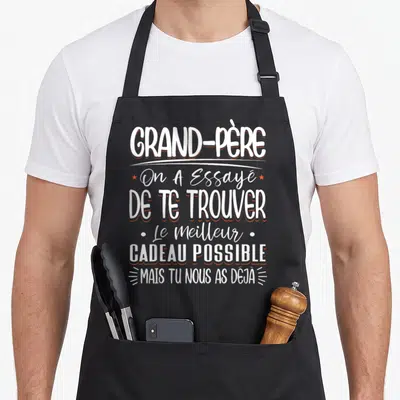 Tablier de cuisine noir avec inscription blanche et orange disant Grand-Père On A Essayé De Te Trouver Le Meilleur Cadeau Possible Mais Tu Nous As Déjà