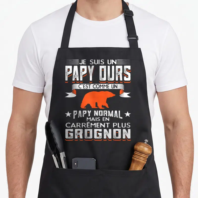 Tablier de cuisine noir avec silhouette d'ours orange et texte blanc Je suis un papy ours carrément plus grognon.