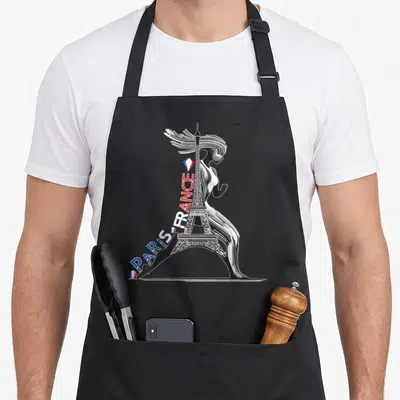 Tablier de cuisine noir avec une femme silhouette fusionnant avec la Tour Eiffel et les mots Paris France en couleurs.