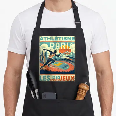 Tablier de cuisine noir avec illustration d'un sprinteur devant un stade et le texte Athlétisme Paris 1924 Les Jeux des Sports.