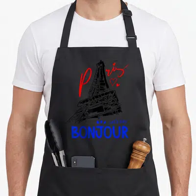 Tablier de cuisine noir avec une illustration de la Tour Eiffel, le mot Bonjour en bleu et Paris en rouge script.