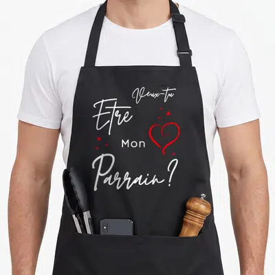Tablier de cuisine noir avec inscription blanche Veux-tu être mon parrain et un cœur rouge entouré d'étoiles.