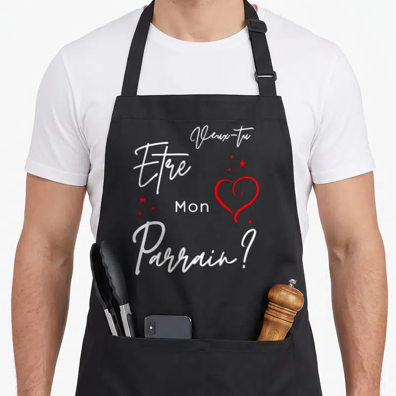 Tablier de cuisine noir avec inscription blanche Veux-tu être mon parrain et un cœur rouge entouré d'étoiles.
