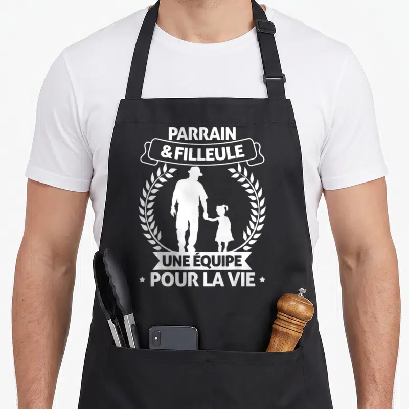 Tablier de cuisine noir avec silhouette parrain et filleule tenant la main encadrée de couronnes de laurels blancs.