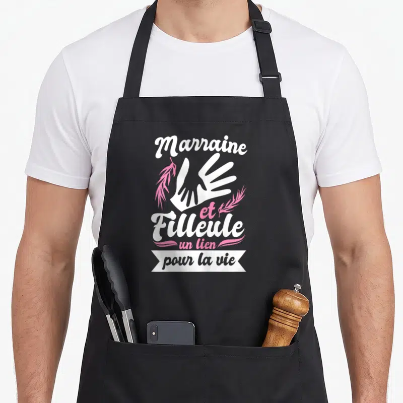 Tablier de cuisine noir avec inscription Marraine et Filleule un lien pour la vie et illustration de mains blanches.
