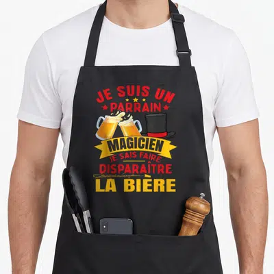 Tablier de cuisine noir avec deux verres de bière, chapeau haut de forme et texte Je Suis Un Parrain Magicien.