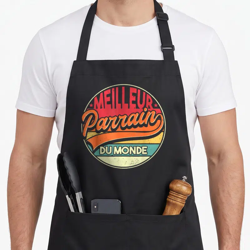 Tablier de cuisine noir avec logo circulaire vintage Meilleur Parrain Du Monde en couleurs vives.