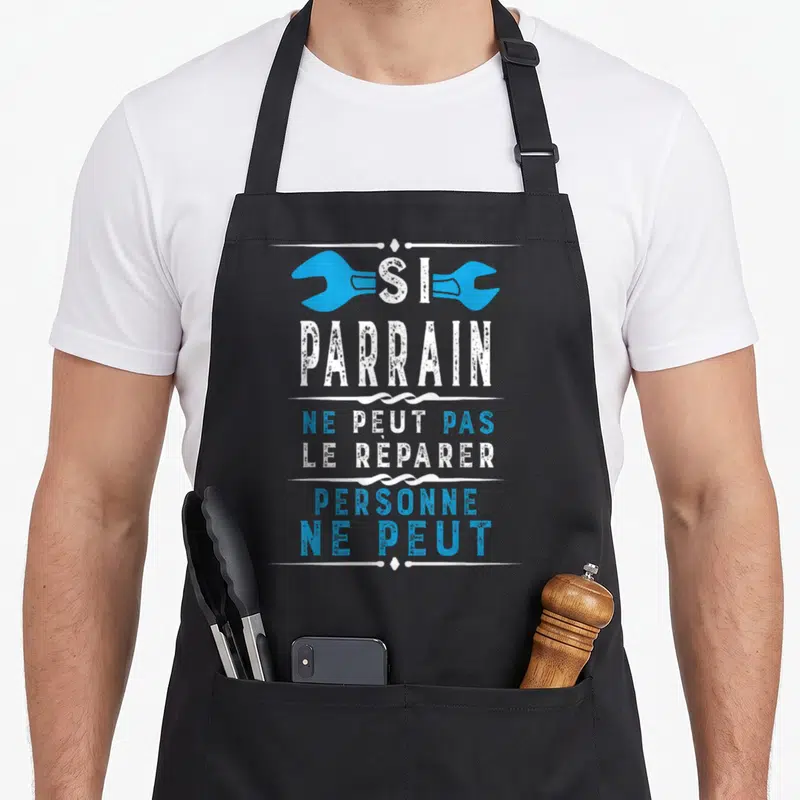 Tablier de cuisine noir avec inscription blanche et bleue Si Parrain Ne Peut Pas Le Réparer Personne Ne Peut surmontée de deux clés.
