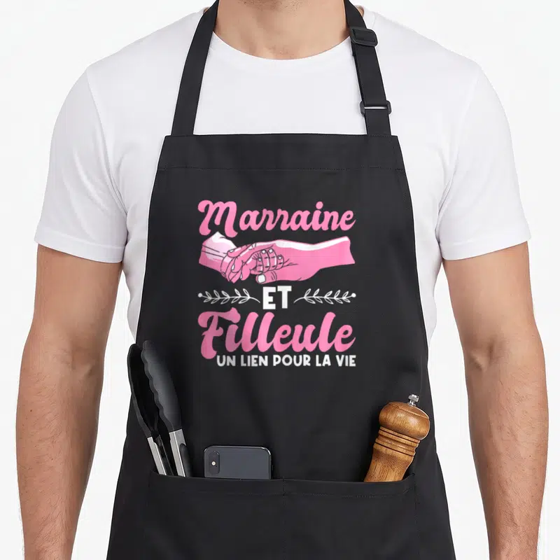 Tablier de cuisine noir avec inscription Marraine et Filleule Un lien pour la vie et illustration de deux mains jointes en rose.