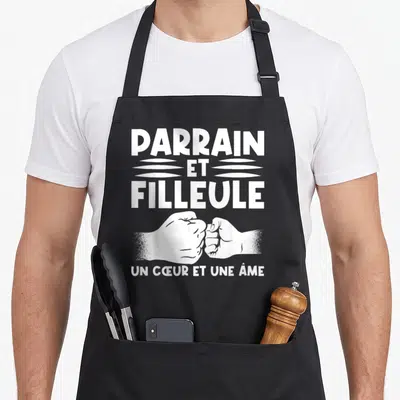 Tablier de cuisine noir avec inscription parrain et filleule un cœur et une âme et illustration de deux poings qui se touchent.