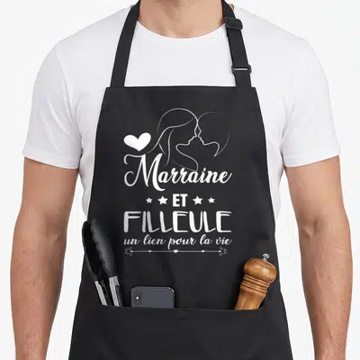 Tablier de cuisine noir avec inscription Marraine et Filleule un lien pour la vie et silhouettes féminines blanches.