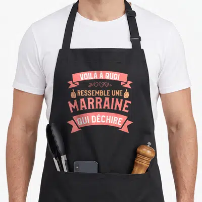 Tablier de cuisine noir avec inscription Voilà à quoi ressemble une marraine qui déchire en rose et orange sur fond uni.