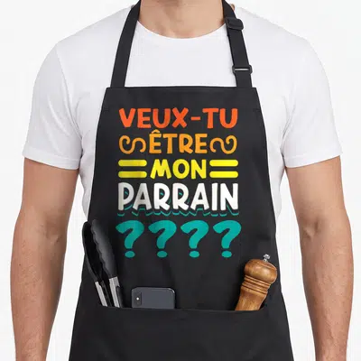 Tablier de cuisine noir avec inscription Veux Tu Etre Mon Parrain et points dinterrogation bleus.