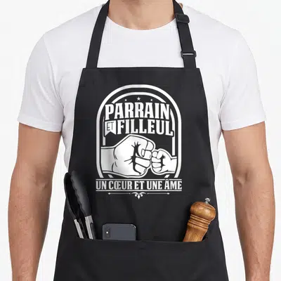 Tablier de cuisine noir avec illustration blanche de deux poings se touchant et le texte Parrain et filleul un cœur et une âme.