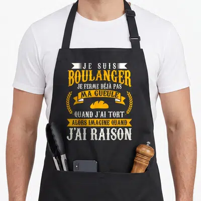 Tablier de cuisine noir avec texte jaune et blanc Je Suis boulanger ma gueule illustration de pain et épis de wheat.