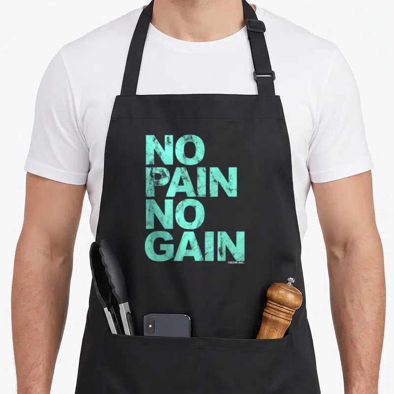 Tablier de cuisine noir avec l'inscription No Pain No Gain en lettres capitales turquoise texturées sur le devant.