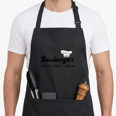 Tablier de cuisine noir avec inscription Boulanger et illustration de toque blanche stylisée au centre.