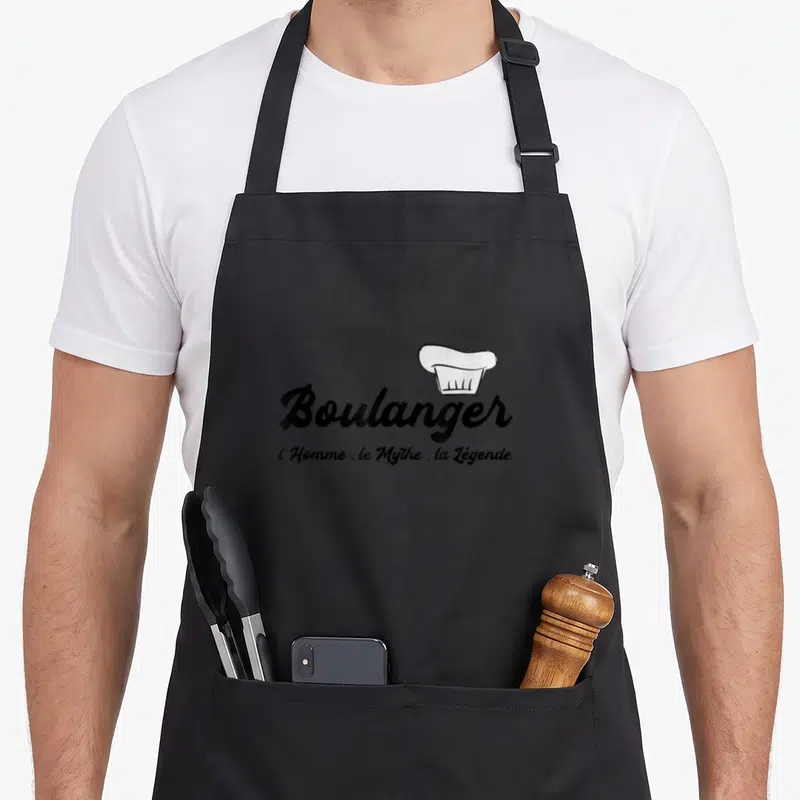 Tablier de cuisine noir avec inscription Boulanger et illustration de toque blanche stylisée au centre.
