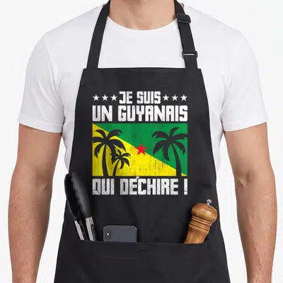 Tablier de cuisine noir avec l'inscription Je suis un Guyanais qui déchire et un drapeau aux palmiers.