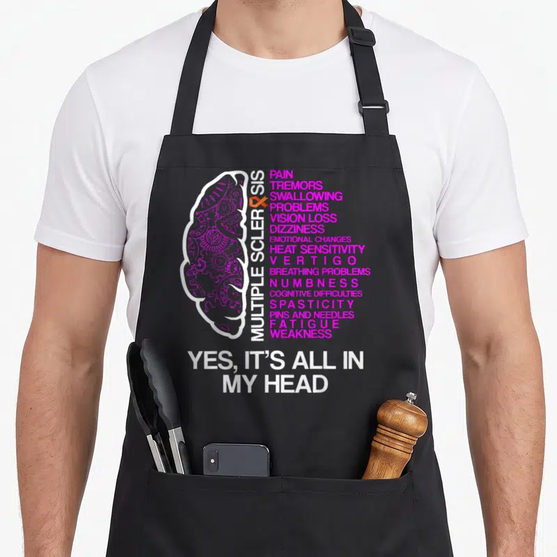 Tablier de cuisine noir avec illustration de cerveau et texte Yes It's All In My Head en blanc et rose vif.