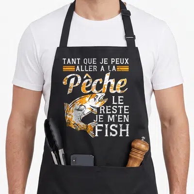 Tablier de cuisine noir avec un poisson sauteur orange et blanc et texte humoristique sur la pêche.