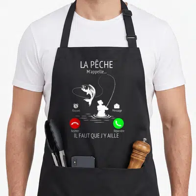 Tablier de cuisine noir avec illustration blanche d'un pêcheur et un poisson sautant sous forme de notification téléphonique.