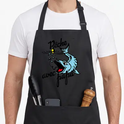 Tablier de cuisine noir avec illustration d'un poisson bleu sautant et du texte Pêche avec papa