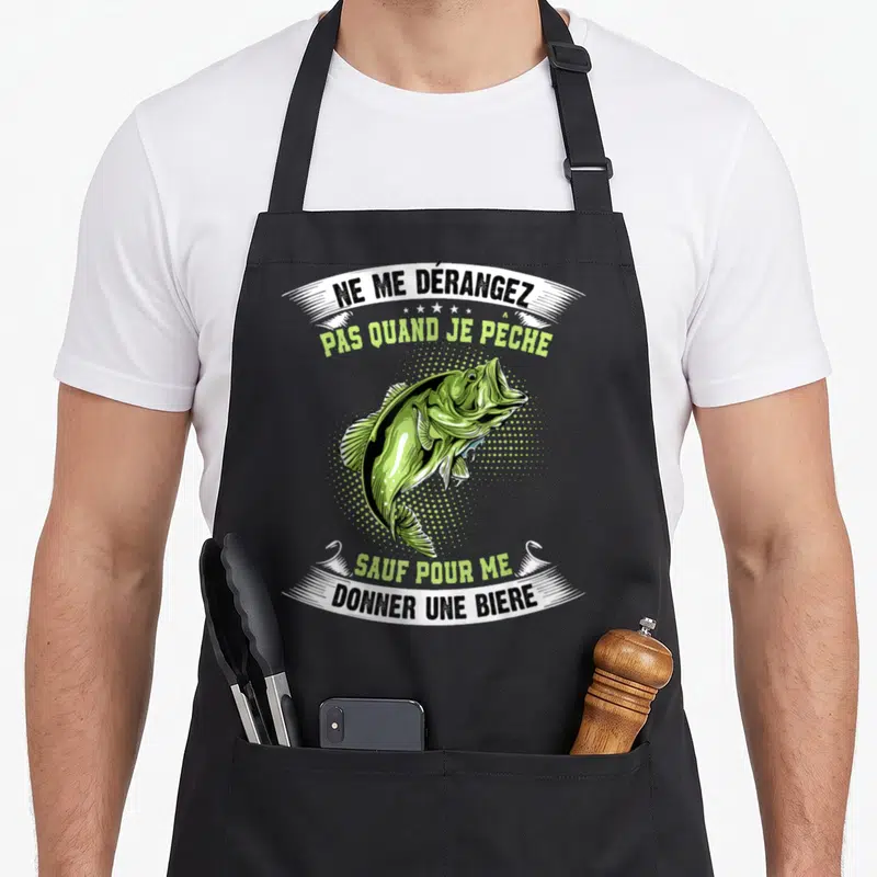 Tablier de cuisine noir avec illustration d'un bar vert et texte humoristique sur la pêche et la bière.