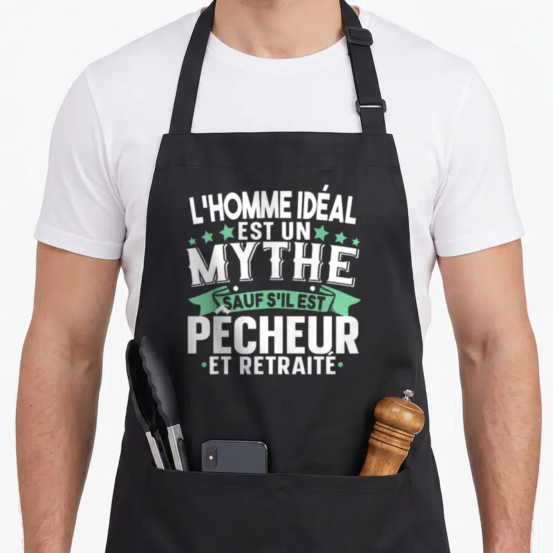 Tablier de cuisine noir avec inscription blanche L'homme idéal est un mythe pêcheur et retraité sur fond vert mint.
