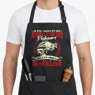 Tablier de cuisine noir avec illustration de brochet et texte rouge affirmant être le top des pêcheurs.