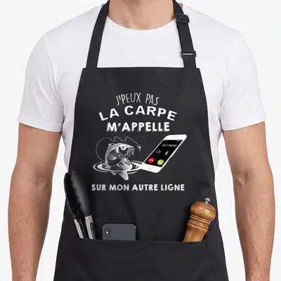 Tablier de cuisine noir avec illustration d'une carpe et d'un téléphone affichant un appel en provenance.