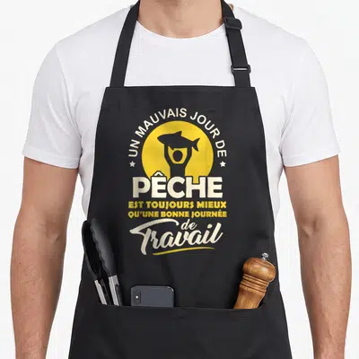 Tablier de cuisine noir avec illustration d'un poisson jaune et texte blanc sur fond circulaire.