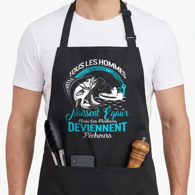 Tablier de cuisine noir avec inscription Tous les hommes naissent égaux mais les meilleurs deviennent pêcheurs et un poisson sautant.