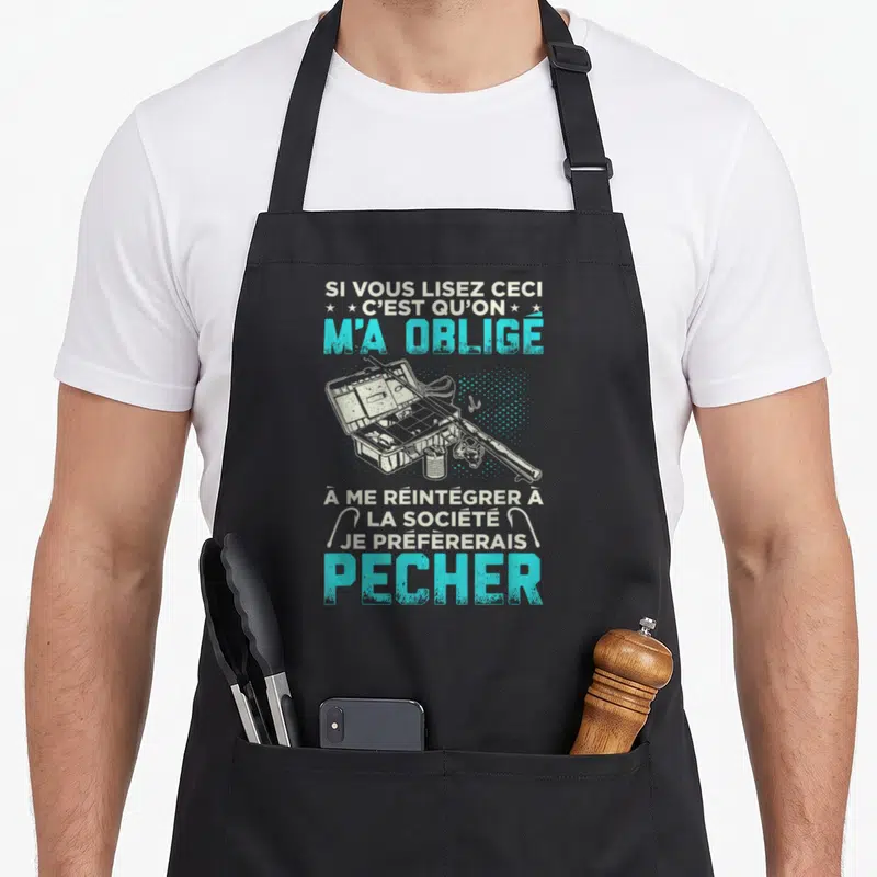 Tablier de cuisine noir avec illustration d'une boîte d'appâts et texte humoristique sur la pêche en bleu et blanc.