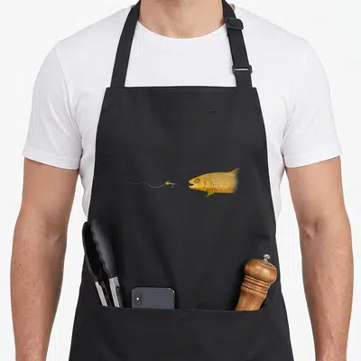Tablier de cuisine noir avec une illustration de truite brune et d'une mouche artificielle sur fil.
