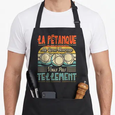 Tablier de cuisine noir avec illustration vintage de trois boules de pétanque et texte humoristique en orange et bleu turquoise.