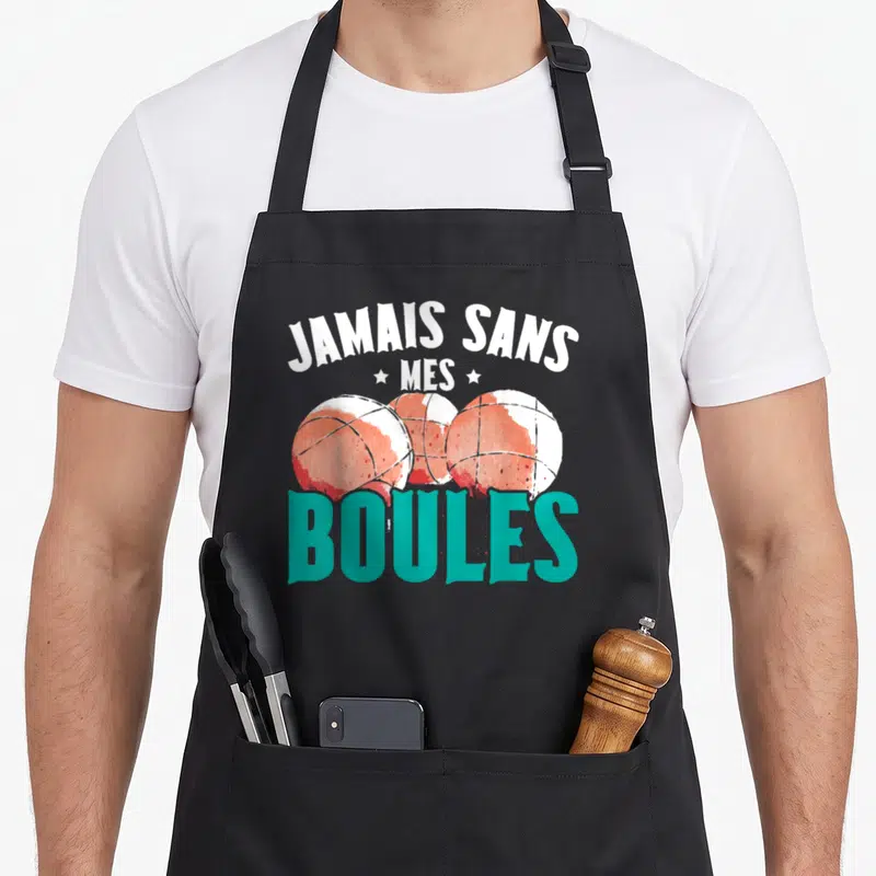 Tablier de cuisine noir avec trois boules de pétanque orange et le texte Jamais sans Mes Boules en turquoise.