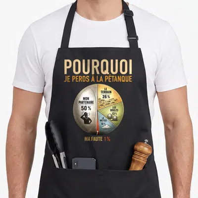Tablier de cuisine noir avec un diagramme circulaire illustrant les causes de la défaite en pétanque et une silhouette de joueur désespéré.