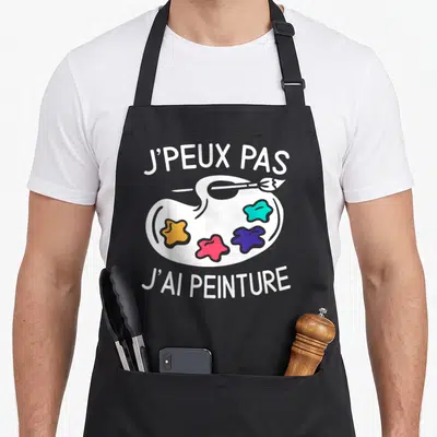 Tablier de cuisine noir avec palette de peintre colorée et inscription Je peux pas j'ai peinture en blanc.