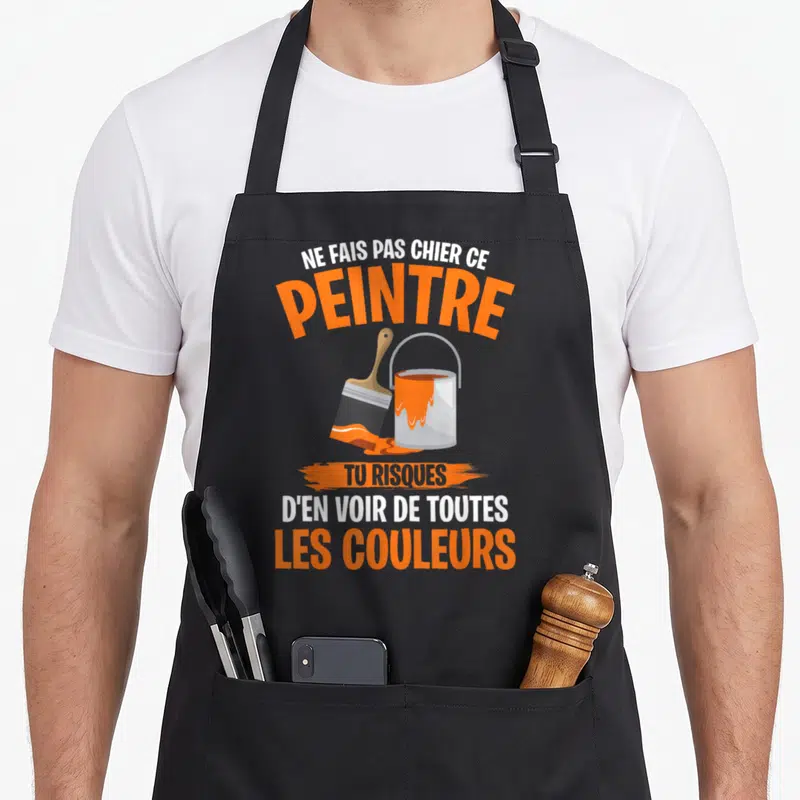 Tablier de cuisine noir avec illustration de pinceau, pot de peinture orange et texte humoristique en blanc et orange.