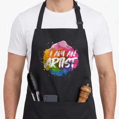 Tablier de cuisine noir avec inscription Je suis un artiste sur une éclaboussure de peinture multicolore.