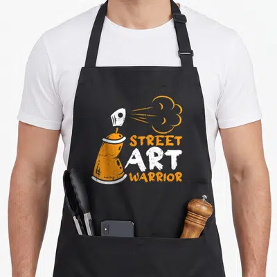 Tablier de cuisine noir avec illustration bombe orange et texte Street Art Warrior en blanc et orange.
